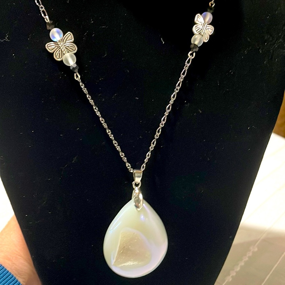 Handmade necklace with large white stone pendant.